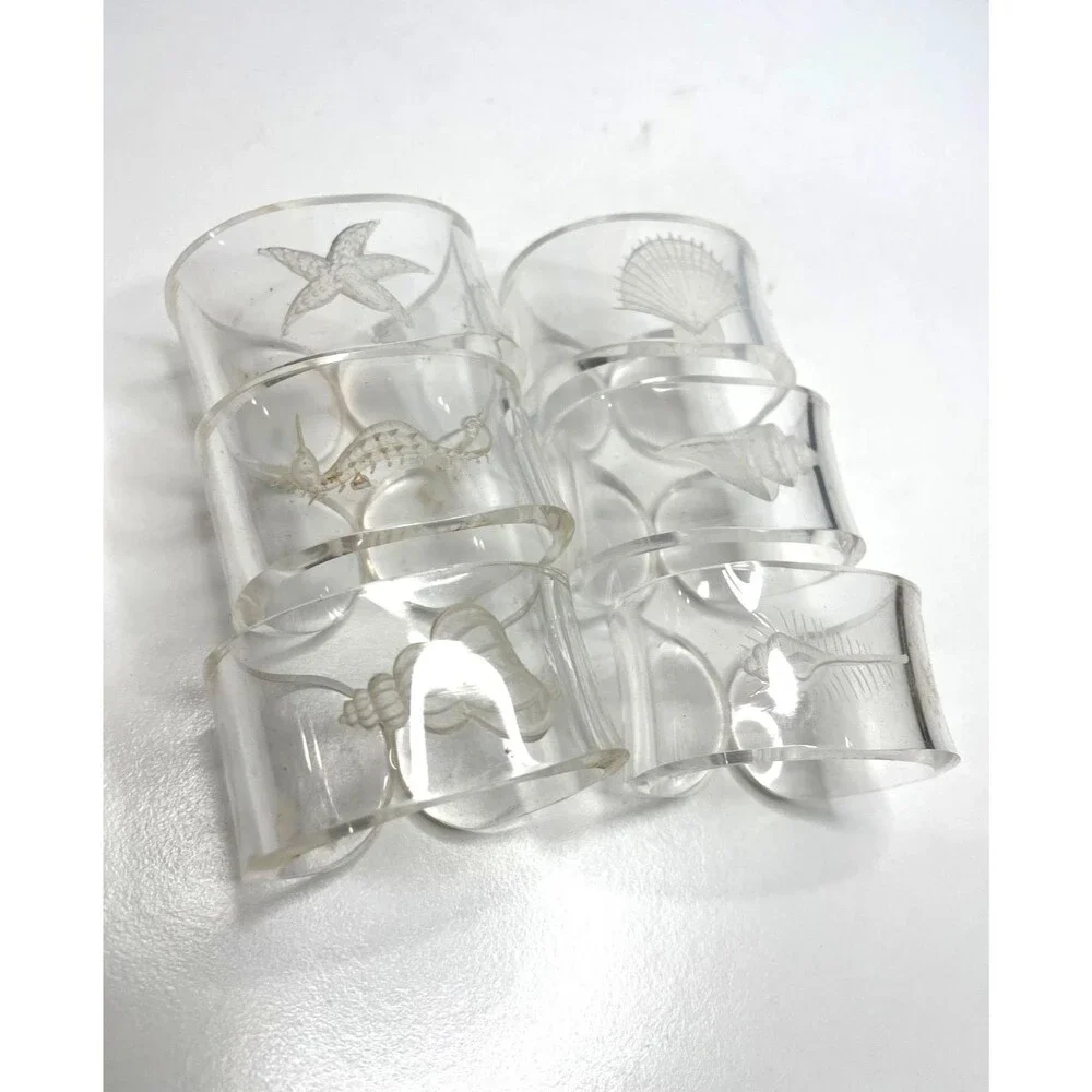 SET OF 6-CLEAR ACRYLIC NAPKIN RINGS ETCHED  ASSORTED SHELLS on each